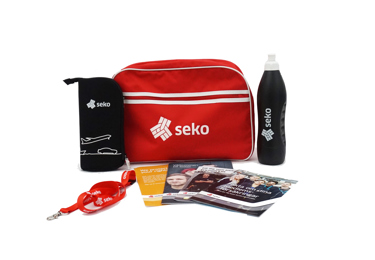 En samling profilprodukter från Seko, bland annat en väska, en vattenflaska, godis och trycksaker.